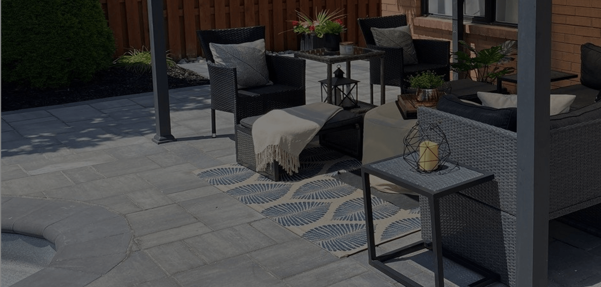 Modern outdoor patio with interlocking stone and lounge seating