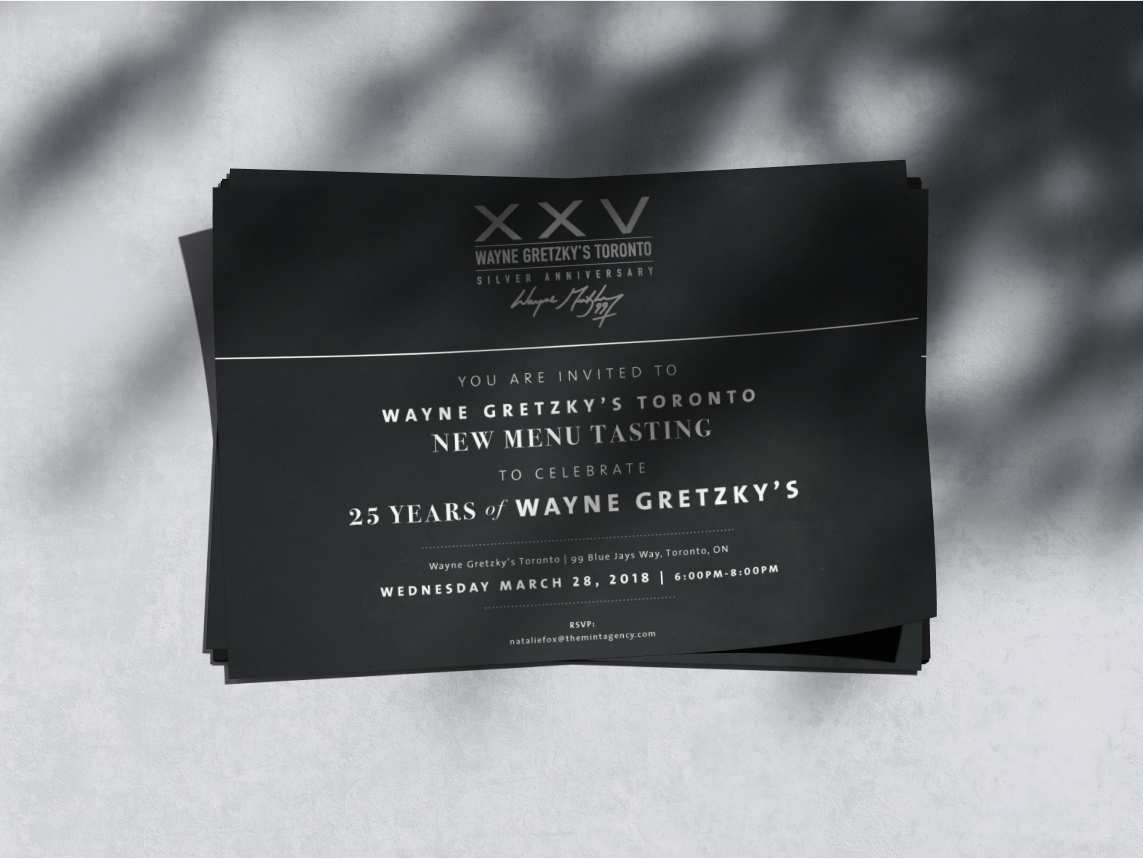 Invitation card for 25 years of Wayne Gretzky’s Restaurant featuring sleek black design with white typography and event details