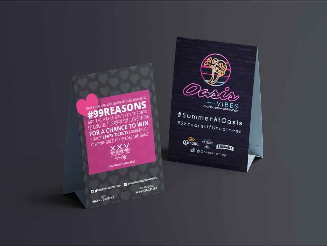 Printed table signage with heart-themed Valentine’s Day contest and #SummerAtOasis coaster-style summer promo for in-venue guests