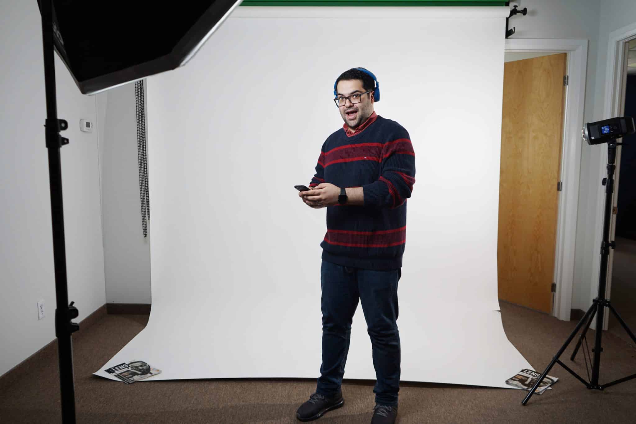 A man standing in front of a camera in a studio.