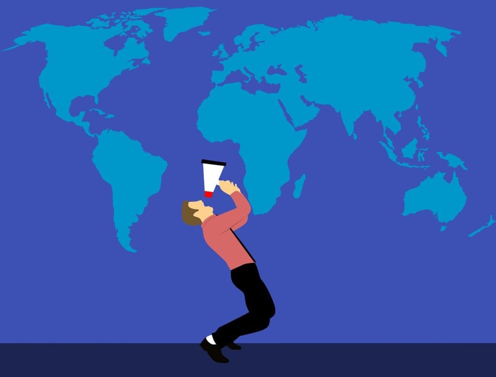 Graphic design image of man yelling on megaphone in front of backdrop of world map