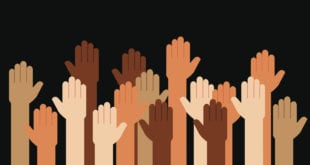 Multi-racial hands raised for anti-racism