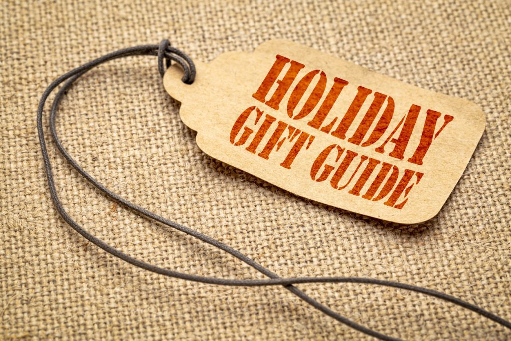 Holiday marketing gift guide sign - a paper price tag with a twine against burlap canvas
