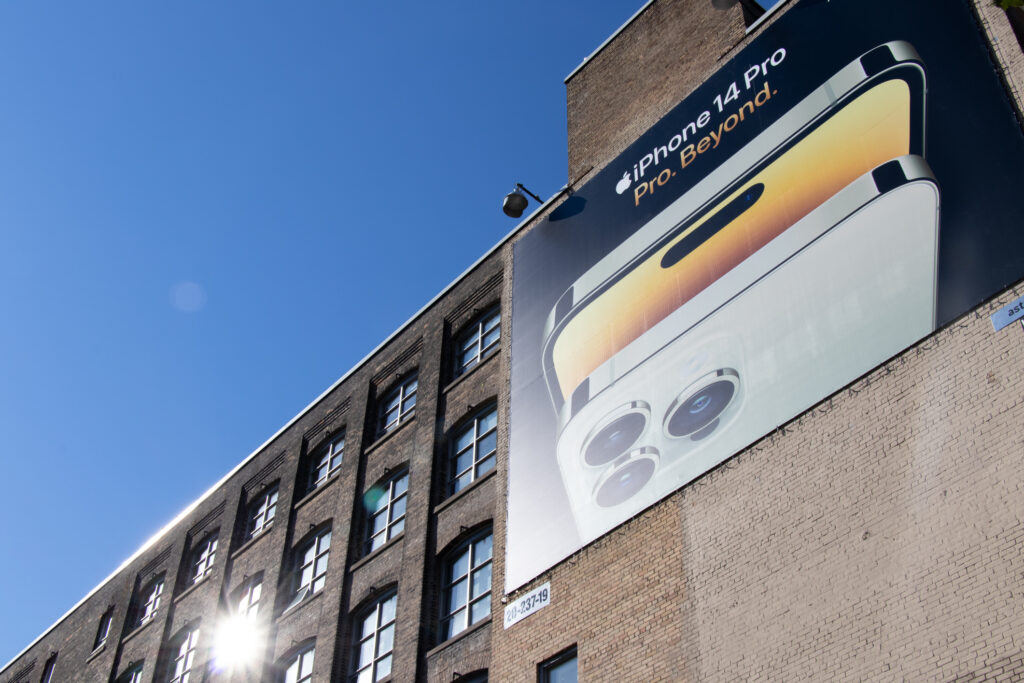 Poster ad for smartphone hanging on a building in downtown Toronto. 
