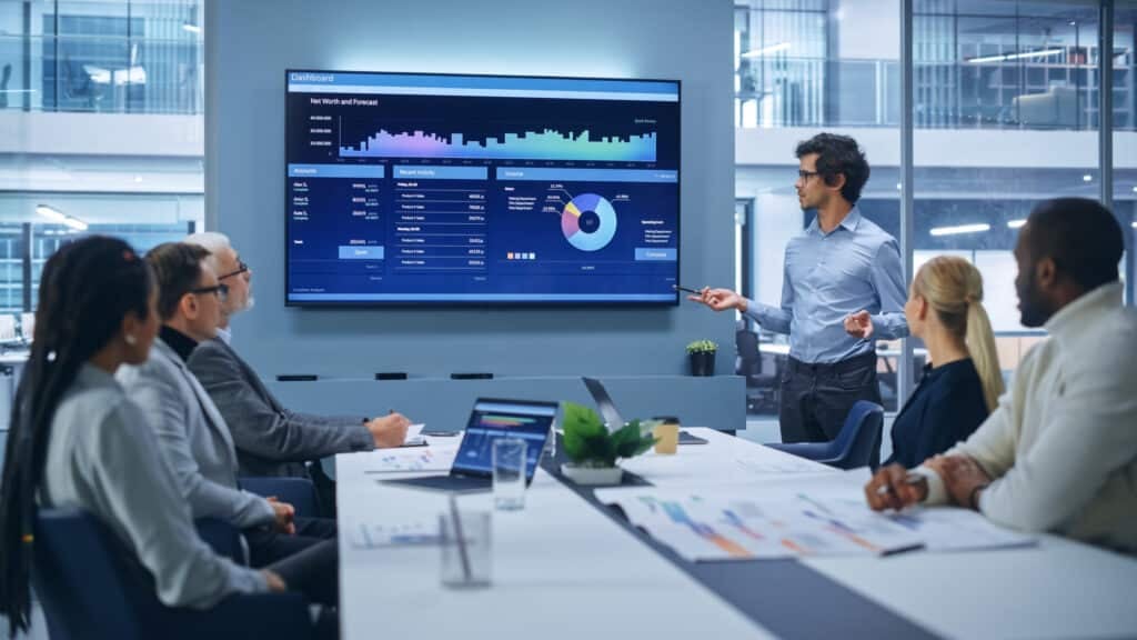 Man presenting digital marketing analytics in an office conference meeting room. 