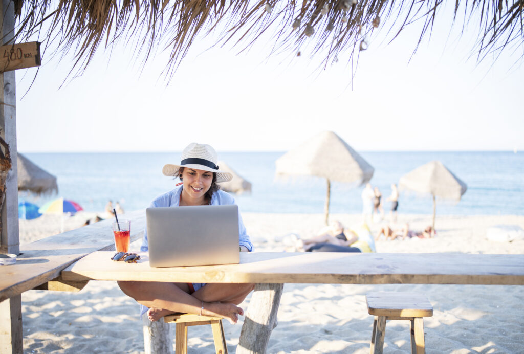 Female digital marketer on the beach