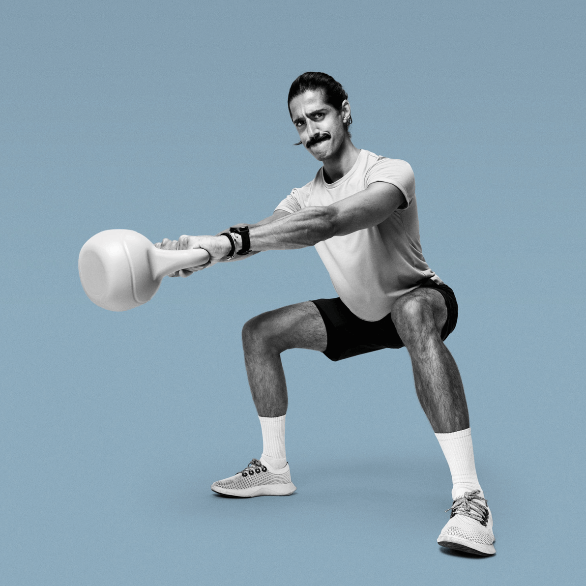 Movember campaign participant swinging a kettlebell.